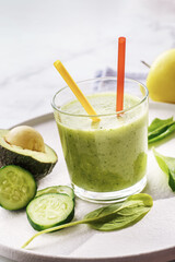 Fresh green smoothie with cucumbers, avocado, spinach and apple