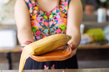 Unrecognizable woman with a Traditional Mexican tamal