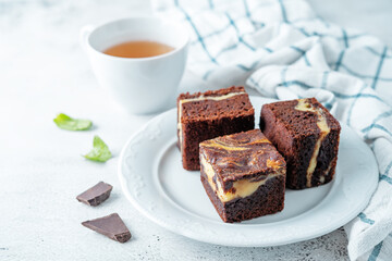 Cream cheese chocolate brownie with mint leaves