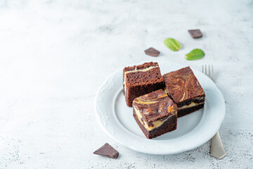 Cream cheese chocolate brownie with mint leaves