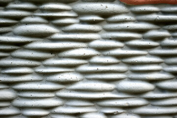 gray figured, concrete fence, close-up as a texture for the background