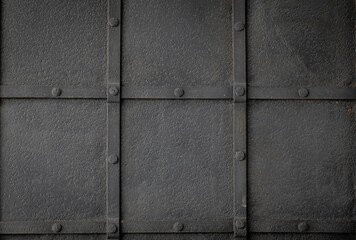 Grunge black metal background with symmetrically arranged trim strips. Square grid finish and design.