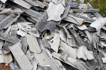 Gray slate, broken into pieces of different shapes and sizes, close-up. Construction waste