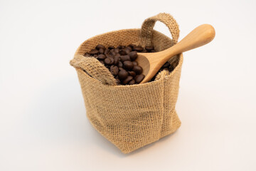 Coffee beans in hemp sack bag isolated on white background.