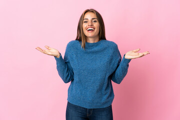 Young Uruguayan woman isolated on pink background smiling a lot