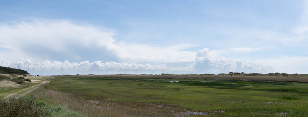 Wetland in the dune area of West-Terschelling Waddenisland The Netherlands with a cloudscape