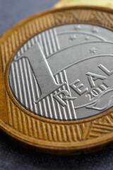 Brazilian 1 one real coin close-up. Money in Brazil. Vertical illustration about economy, finance and banks. National currency real. Macro