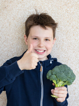Portrait of a boy with broccoli