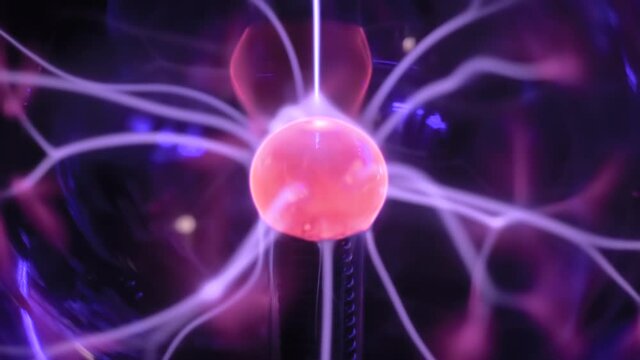 Close up - plasma ball with many energy rays inside. Electricity, education, science, futuristic, technology and physics concept