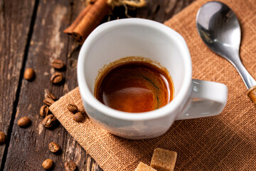Fototapeta na wymiar Ristretto, short shot, of highly concentrated espresso coffee, wooden background