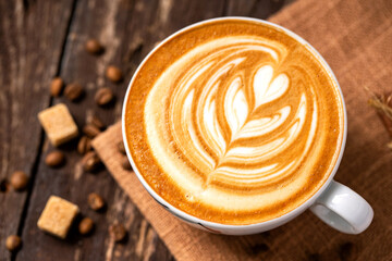 Rosette heart shaped latte coffee art concept on wooden background