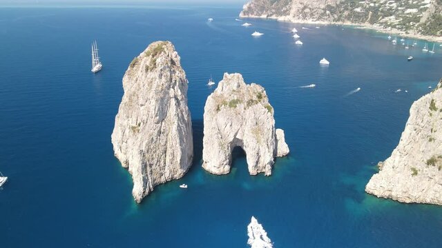 Faraglioni in Capri, Italy. Famous landmark from the drone viewpoint in summer season, Campania