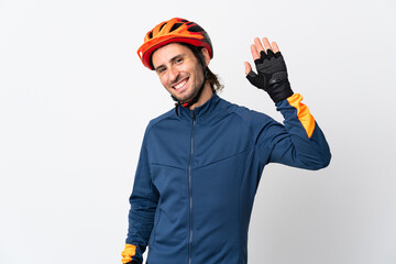 Young cyclist man isolated on white background saluting with hand with happy expression - obrazy, fototapety, plakaty