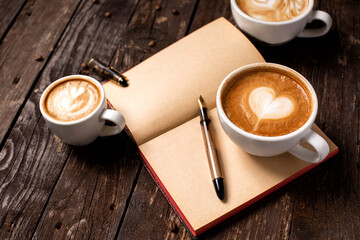 Coffee espresso lungo in rustic latte style with heart shaped motives, wooden background