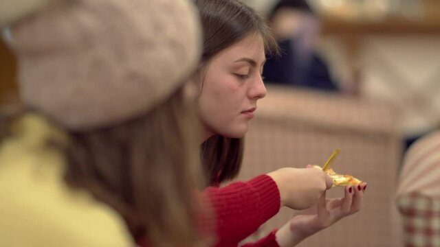 Eating pizza with friends. Close-up