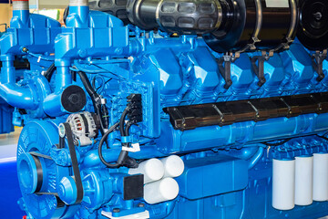 Blue diesel engine. Fragment of a diesel motor close-up. Marine diesel engine with belts. Concept -...