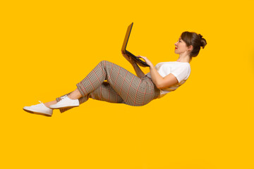 Woman with laptop. Girl dressed in casual style. Freelancer woman creative portrait. Freelancer girl on yellow background. Concept freelance career. Woman works laptop. Metaphor convenient operation