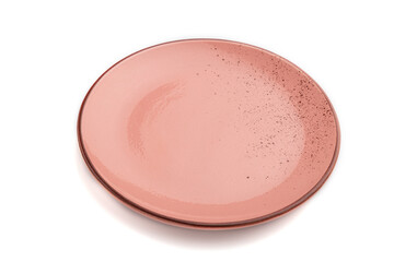 Empty pink dotted ceramic plate isolated on white background. Side view, close up.