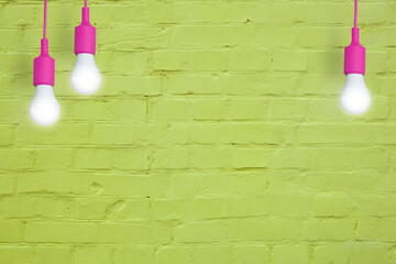 Yellow brick wall with light bulbs. Creative copy space for your text or image