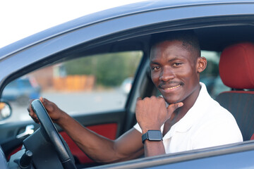 An African-American man driving a car. Human emotions