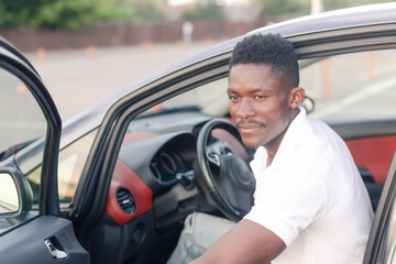 An African-American man driving a car. Human emotions