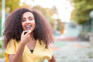 Beautiful smiling African black woman is holding invisaligner. Includes copy and text space.