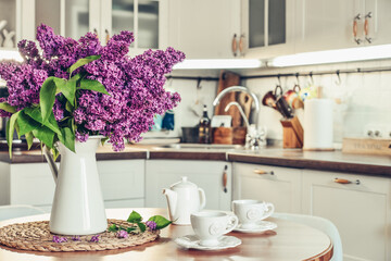 Bouquet of purple Lilac flowers in interior of the kitchen