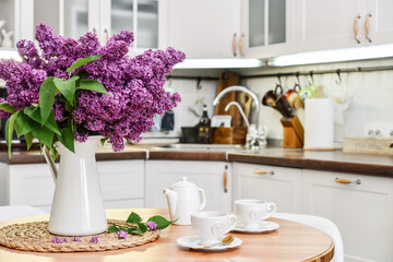 Bouquet of purple Lilac flowers in interior of the kitchen