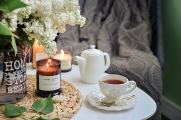 Bouquet of  Lilac flowers on coffee table with cup of tea