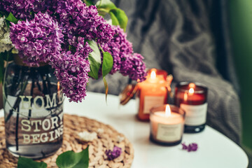 Bouquet of purple Lilac flowers  with burning candles