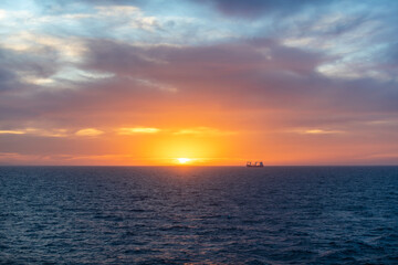 Sunset at sea. Seascape, blue sea.  Calm weather. View from cargo vessel.