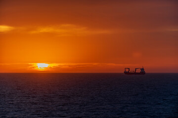 Fototapeta na wymiar Sunset at sea. Seascape, blue sea. Calm weather. View from cargo vessel.
