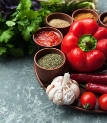  Georgian spices with vegetables on stone background