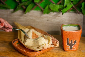 Delicious Mexican tamal with atole
