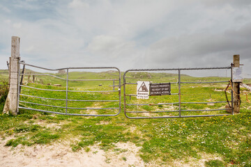 Private property sign on a metal fence in a field
