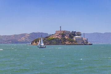 Sunny view of the Alcatraz Island and San Francisco Bay with a boat