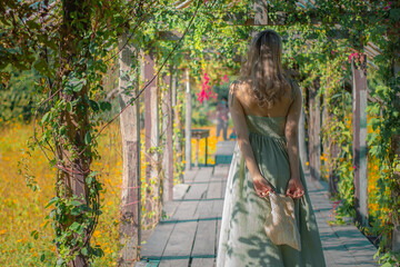 woman walking in the yellow flower garden 