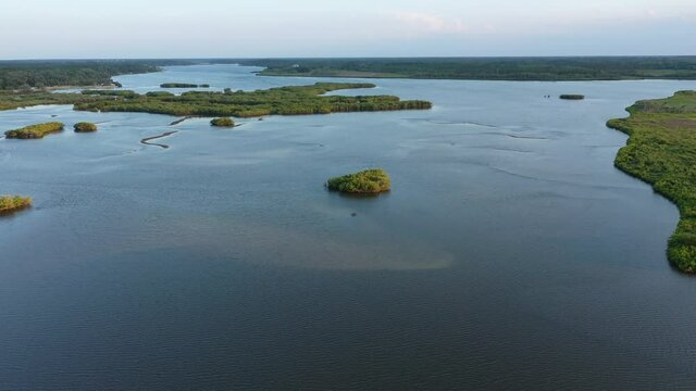 Aerial view of the beautiful salt marsh and red mangroves of the Spruce Creek coastal basin including Strickland Bay and Turnbull Bay. Looking south in the late afternoon.