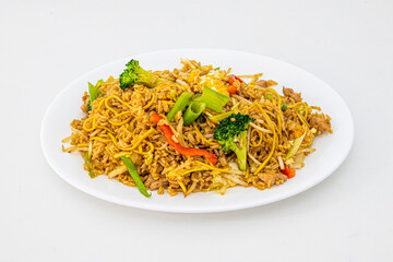 Fried rice with noodles, sautéed vegetables and chicken pieces with soy sauce and sprouts, chopped chives and white tray