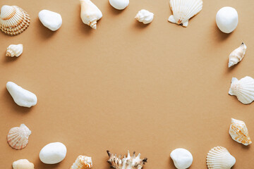 Seashells frame on sandy background top view. Summer vacation concept.
