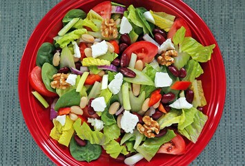 Meatless high protein vegetarian dinner salad plate of selected vegetables, nuts and legumes food background