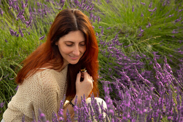 woman with red hair among lavender flowers