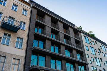 modern darken brick facade with big blue windows