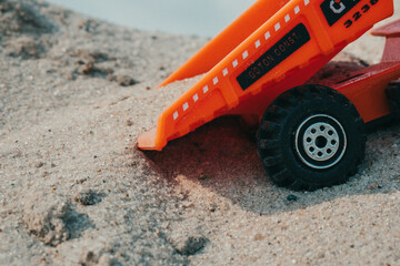 Truck in a sand quarry. Large excavator loads rock with iron or bauxite mining dump truck in a quarry against the sky