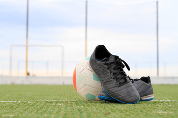 soccer boots with the ball in the center of the field with a view of the goal