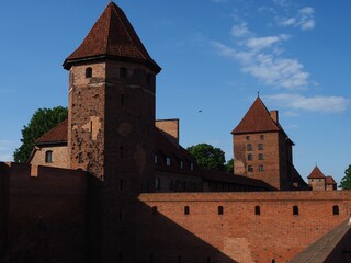 Malbork Castle towers against blue sky