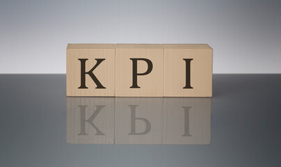 KPI concept, wooden word block on the grey background