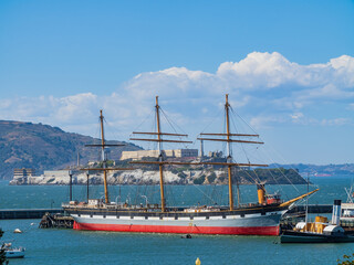 Sunny view of the Alcatraz Island and San Francisco Bay with a vessel ship