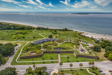 Obraz premium Aerial view of Fort Moultrie on Sullivan's island Charleston, South Carolina from the American Revolutionary war protecting the harbor with gun battery blue cloudy sky