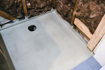 shower renovation with shower walls interior exposed and waterproofing on the shower base floor,...